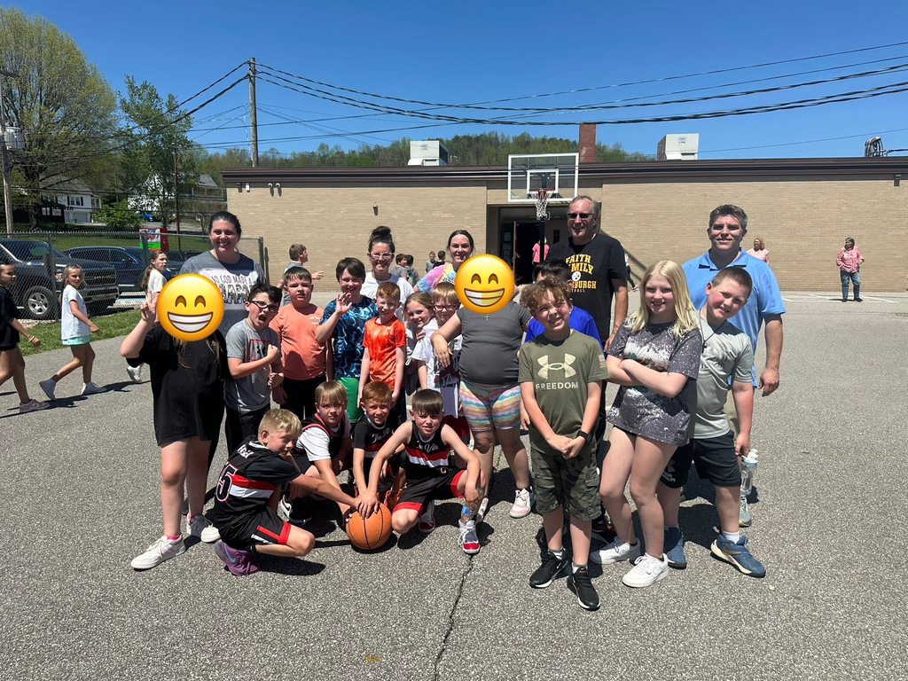 group picture of the third grade class and staff members after the basketball game. 