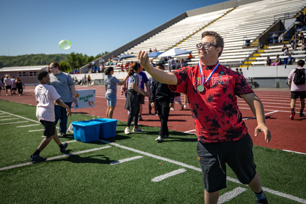 a nitro high school student competing in a water ballon throwing contest. 