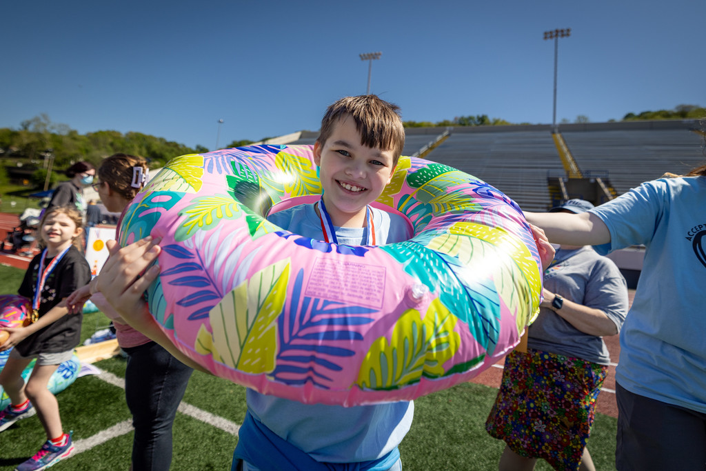 a student with a life ring around his shoulders after competing in the human ring toss contest. 
