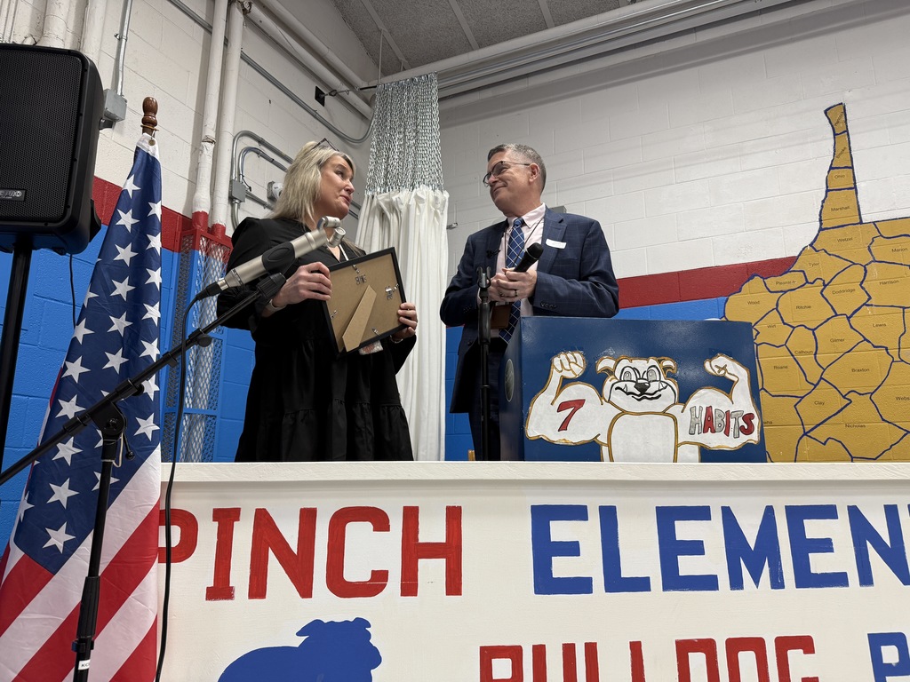 Karen Messinger receiving her principal of the year award from kcs superintendent dr. tom williams
