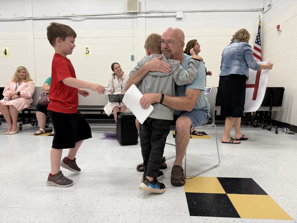 students from richmond elementary giving mr. norman a hug.
