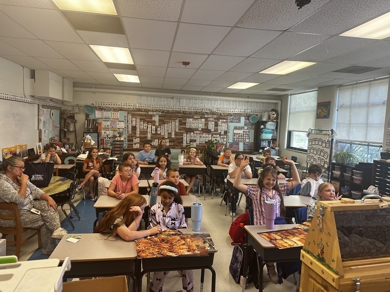 students at belle elementary excited about seeing bees from a local beekeeper making honey.