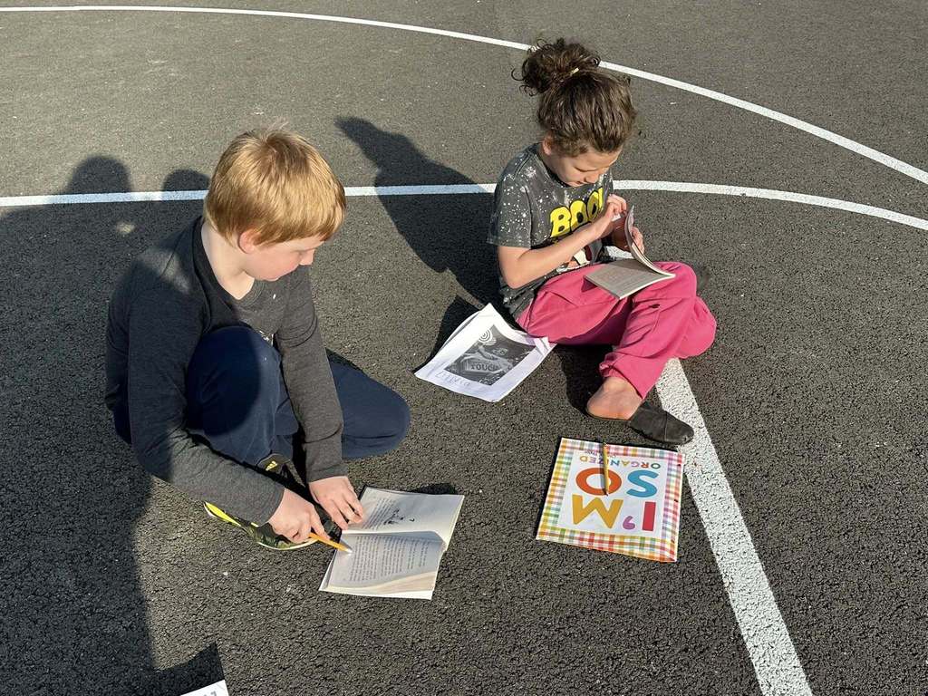 two alum creek students discussing the book.