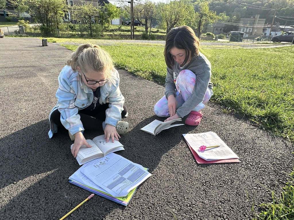 two students going over their book together.