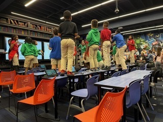 students on top of their classroom tables during an interactive lesson at the ron clark academy.