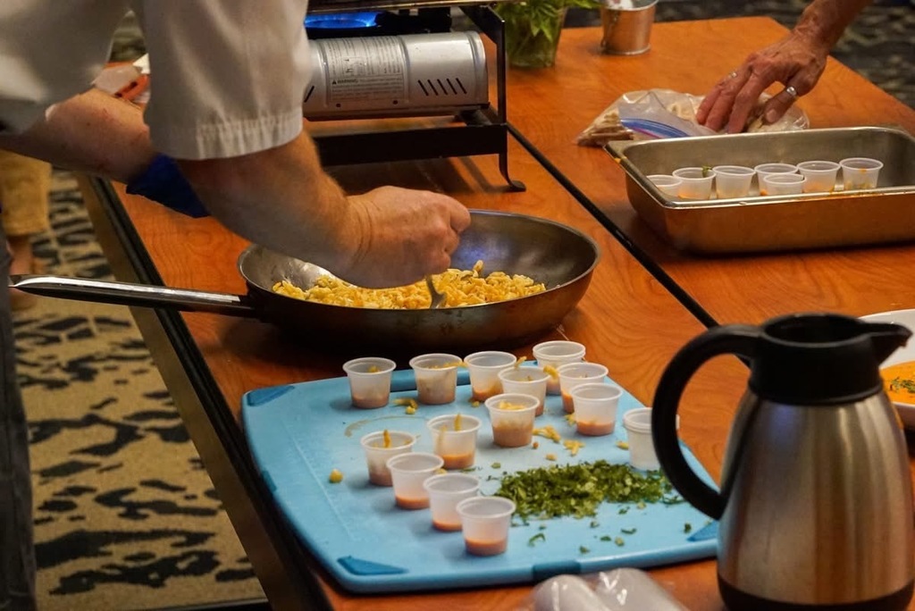 Putting Roasted Red Pepper Coulis and Spatzle in cups for taste testing