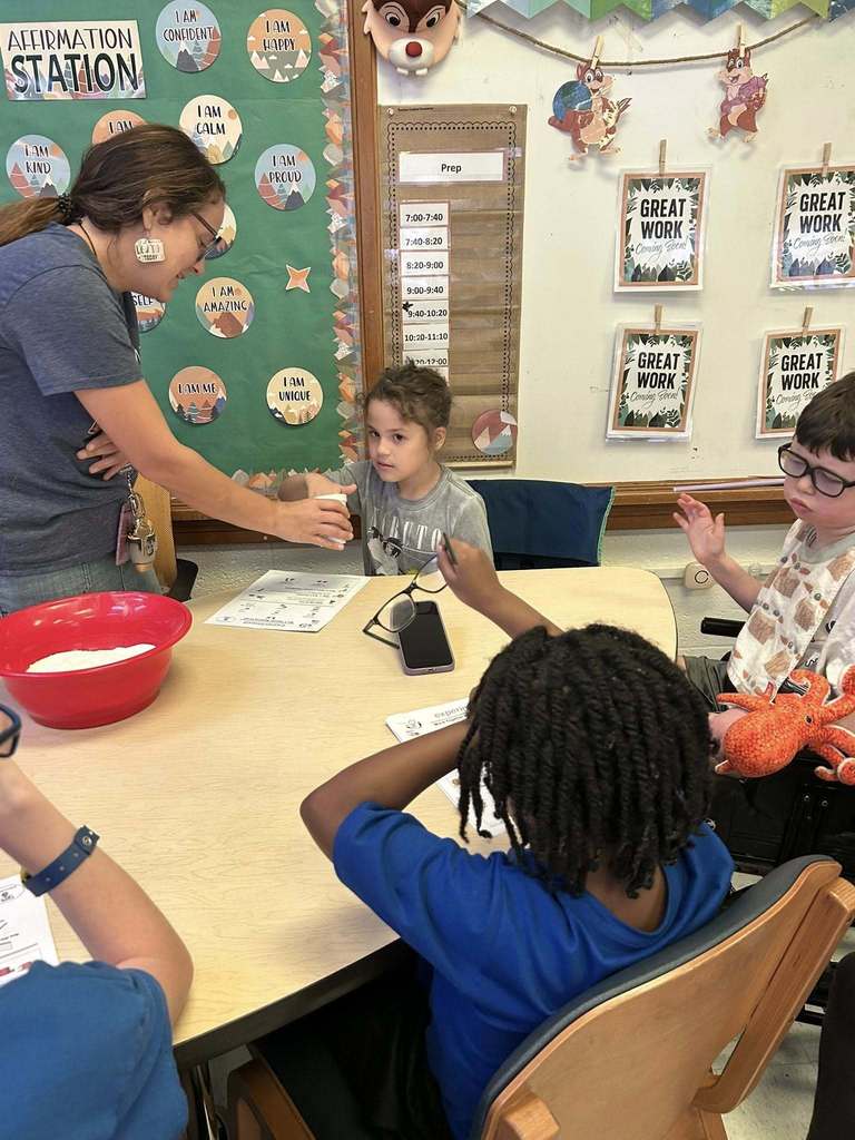 students at kanawha city elementary making their own playdoh during science class.
