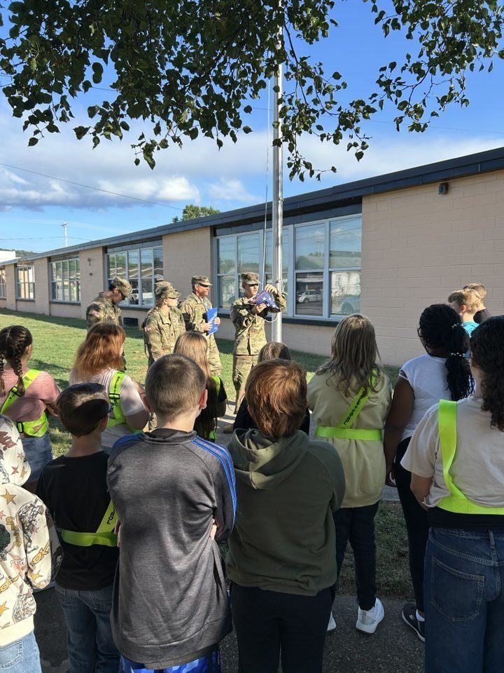 nhs rotc student showing nes students what the american flag looks like when properly folded.