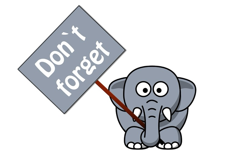 and elephant holding a “don’t forget” sign
