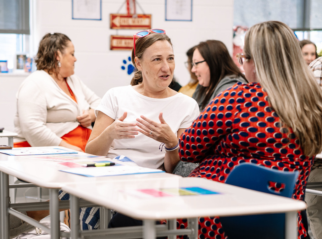 teachers in a meeting at herbert hoover high school learning new lessons to engage students. 