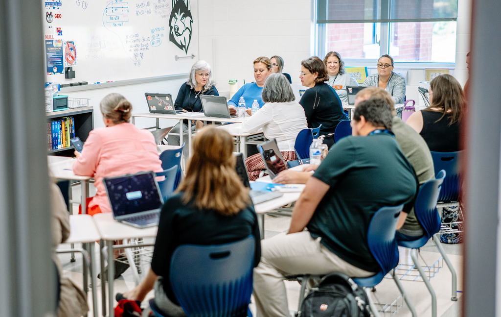 teachers in a meeting at herbert hoover high school learning new lessons to engage students. 