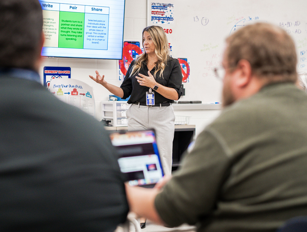 teachers in a meeting at herbert hoover high school learning new lessons to engage students. 