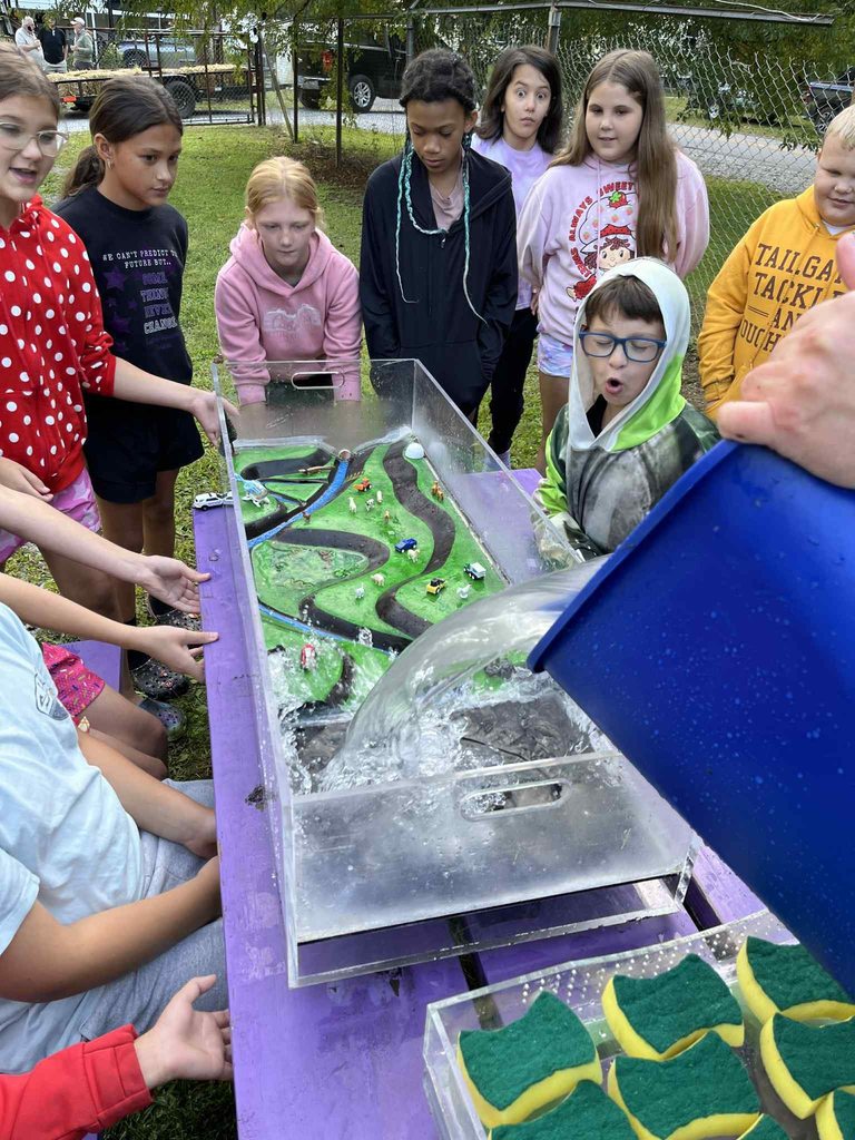 pratt students watching a water experiment.
