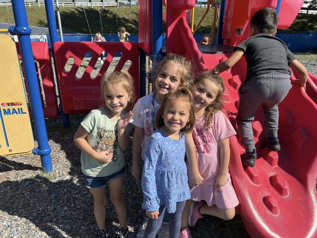 bridgeview elementary kindergarten students standing near the jungle gym on the school's playground.