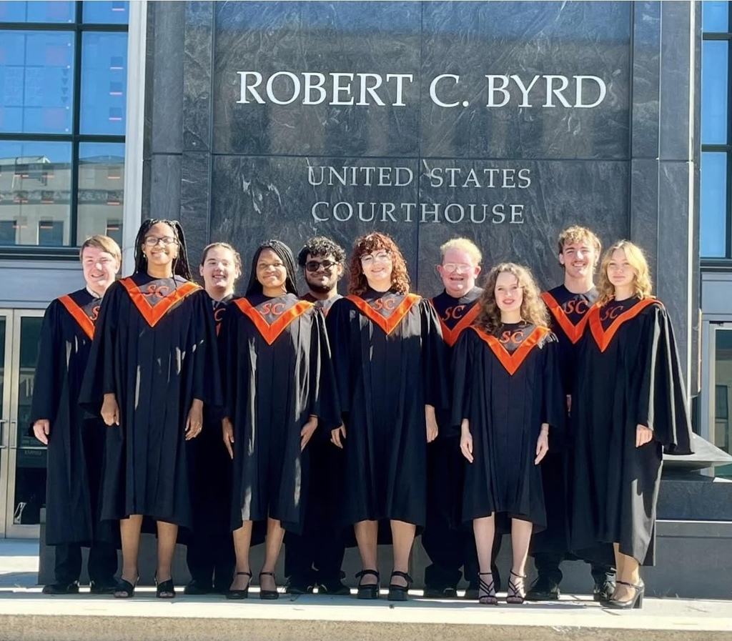 South Charleston High School Vocal Ensemble posing for a picture in front of the Robert C. Byrd Courthouse in Charleston. 