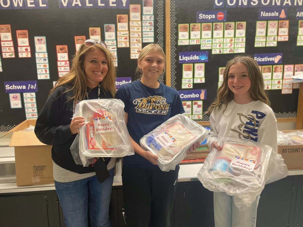 DuPont middle school students dropping off cake kits to the school in their feeder area. 