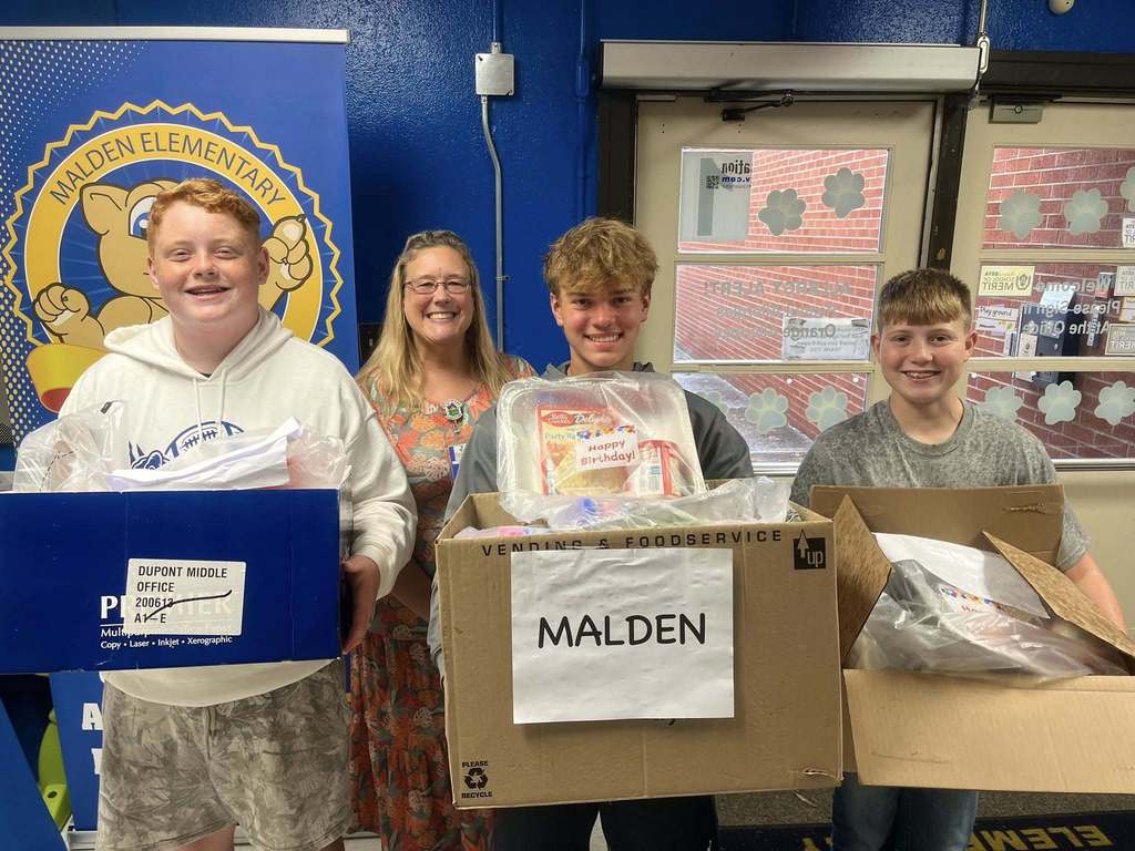 DuPont middle school students dropping off cake kits to the school in their feeder area. 