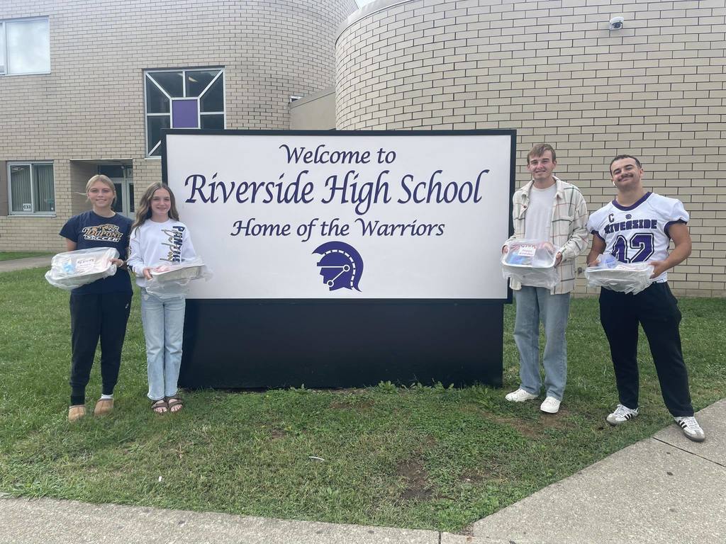 DuPont middle school students dropping off cake kits to the school in their feeder area. 