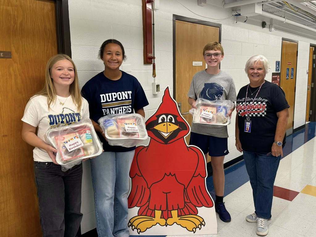 DuPont middle school students dropping off cake kits to the school in their feeder area. 