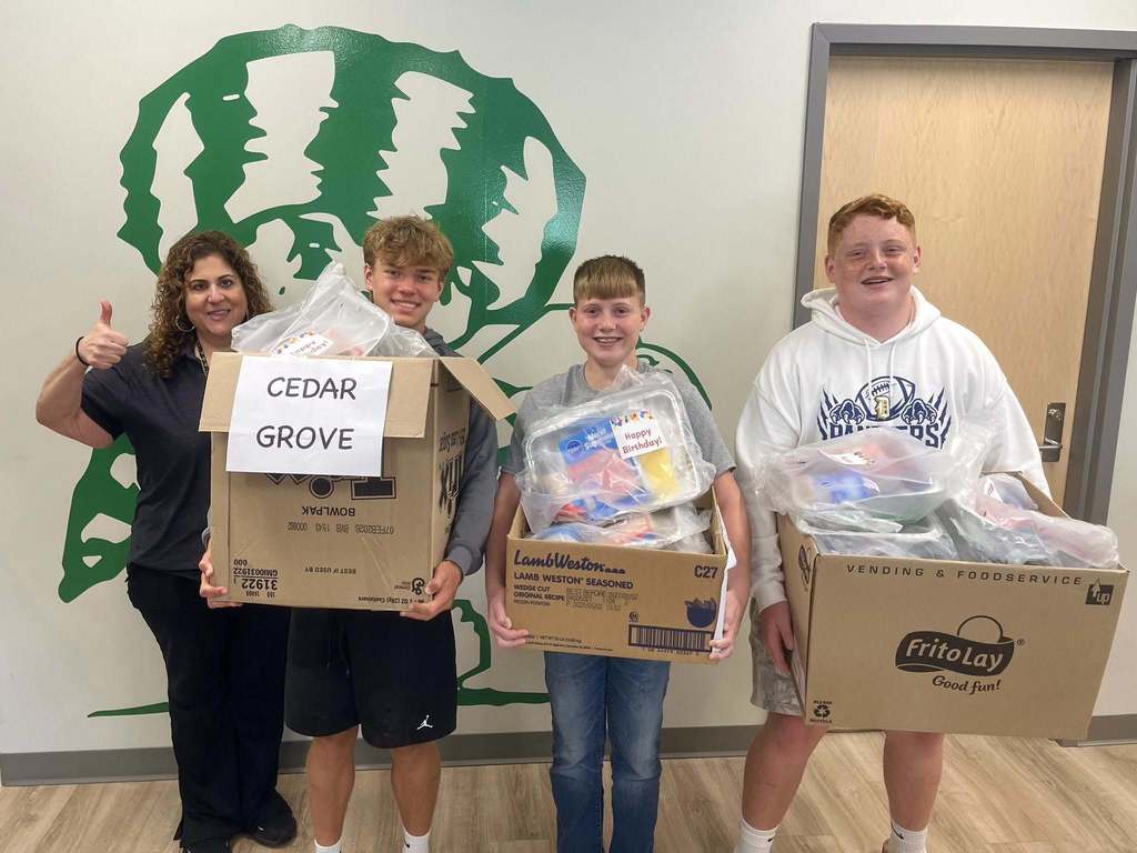 DuPont middle school students dropping off cake kits to the school in their feeder area. 