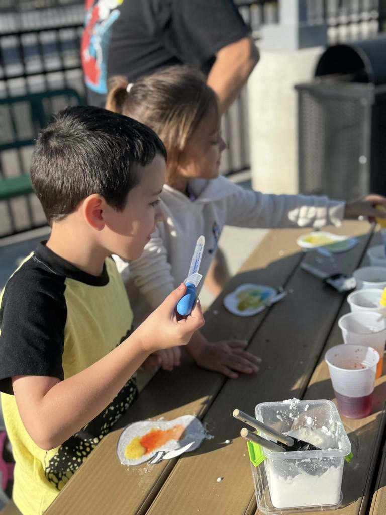 a student getting ready to fill his dropper with water during a stem lesson. 