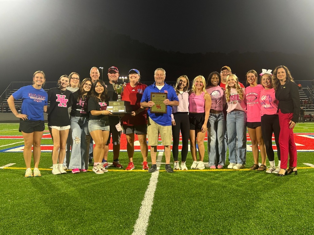 herbert hoover female athletes, herbert hoover principal, Mike Kelley, and WVSSAC rep, Jaclyn Swayne, standing on the hoover football field holding the 2024-2025 health plan champions cup.