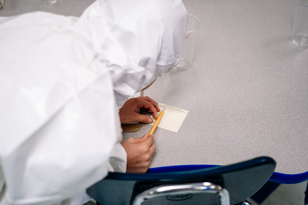 student looking for evidence on a sheet of paper.