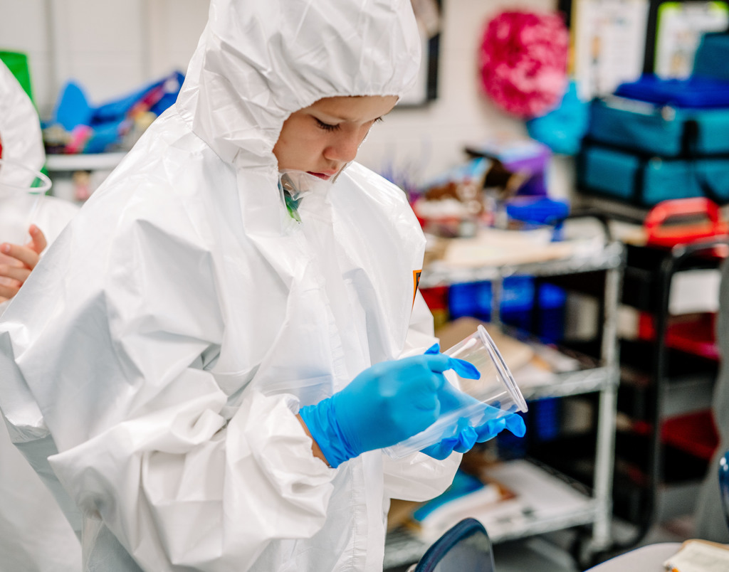 student testing a cup for dna.