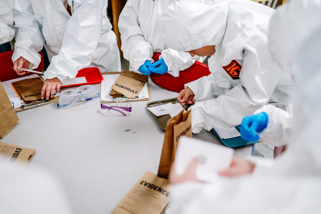 students testing for finger prints at a classroom table