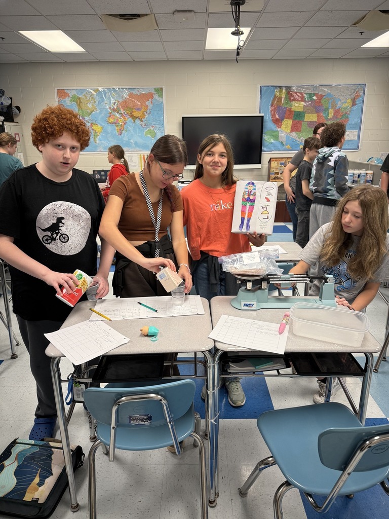 sissonville middle school students measuring ingredients and weighing a chicken during their steam lab.