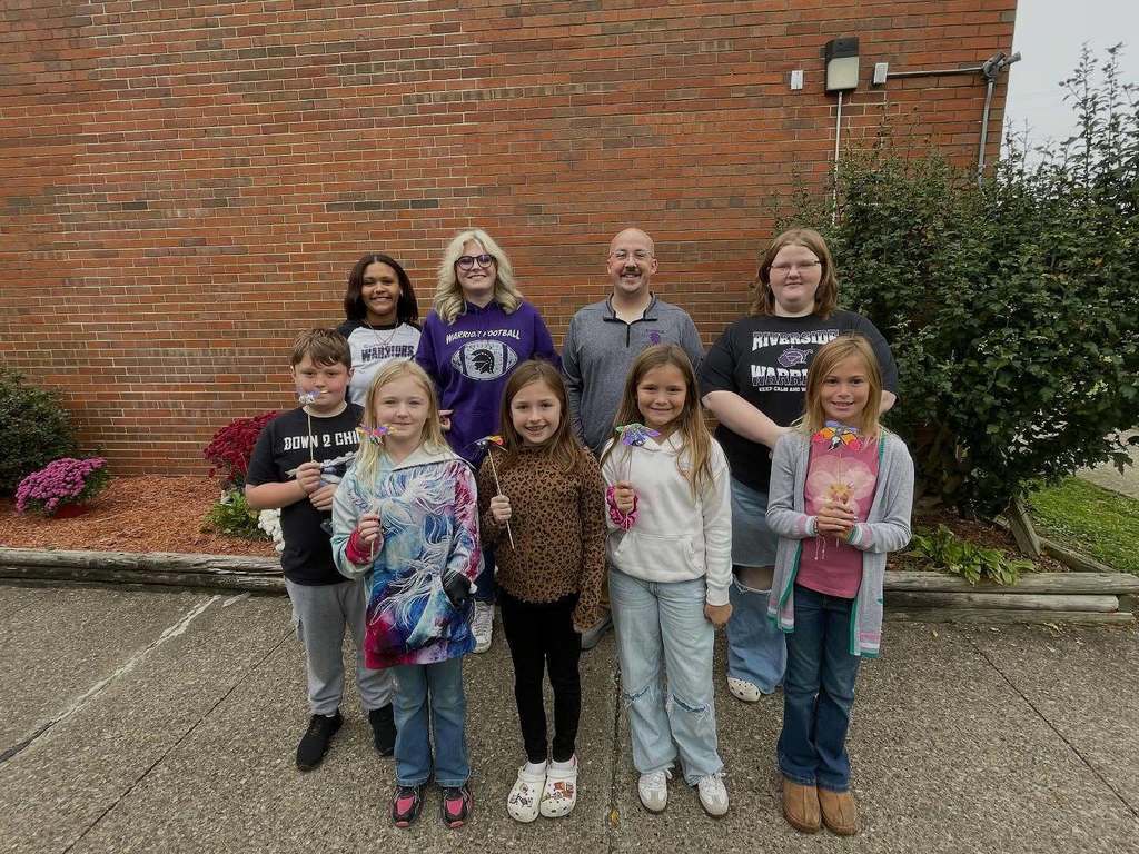 Riverside and midland trail students posing for a picture outside of midland trail elementary school.