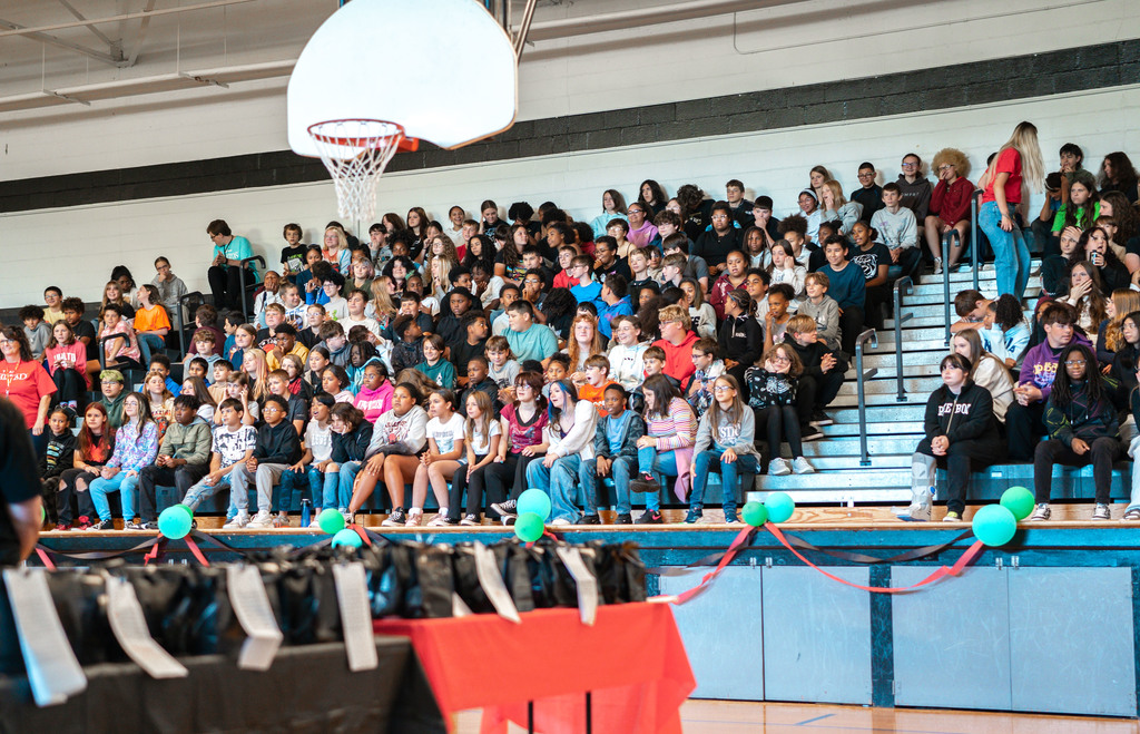 dms students in the school gym waiting for the event to start.