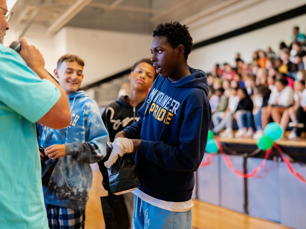 student looking on as his house is revealed.