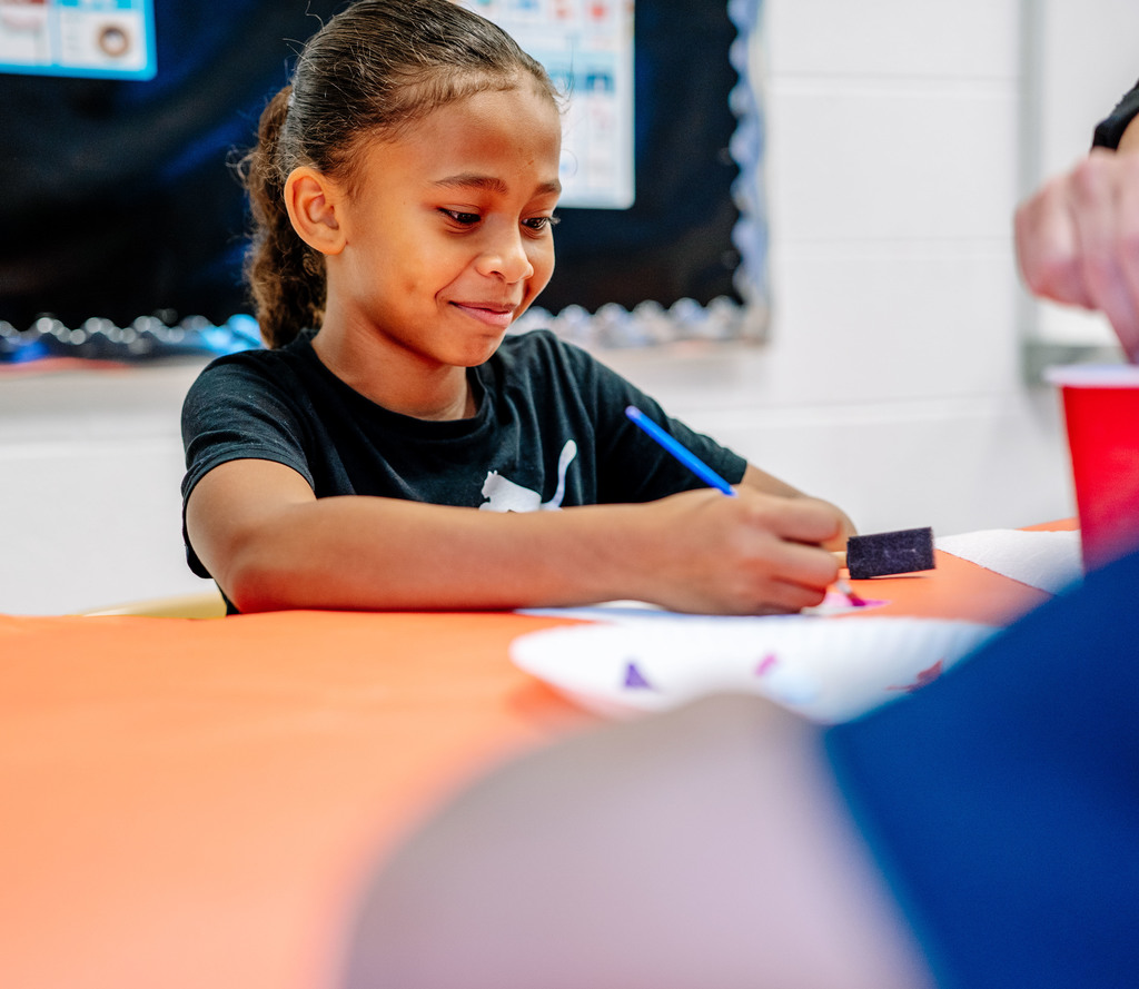 student painting on her paper.