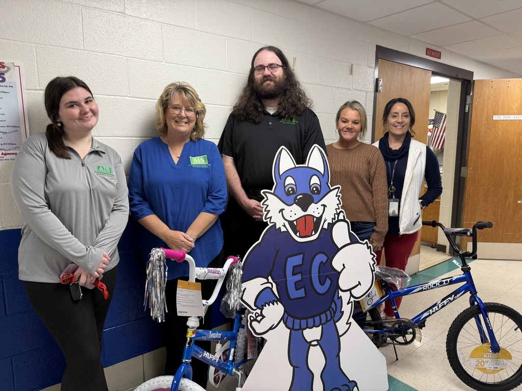 local business owners and elk center elementary principal, kami lucas, posing with new bikes that are being used as prizes for good attendance.