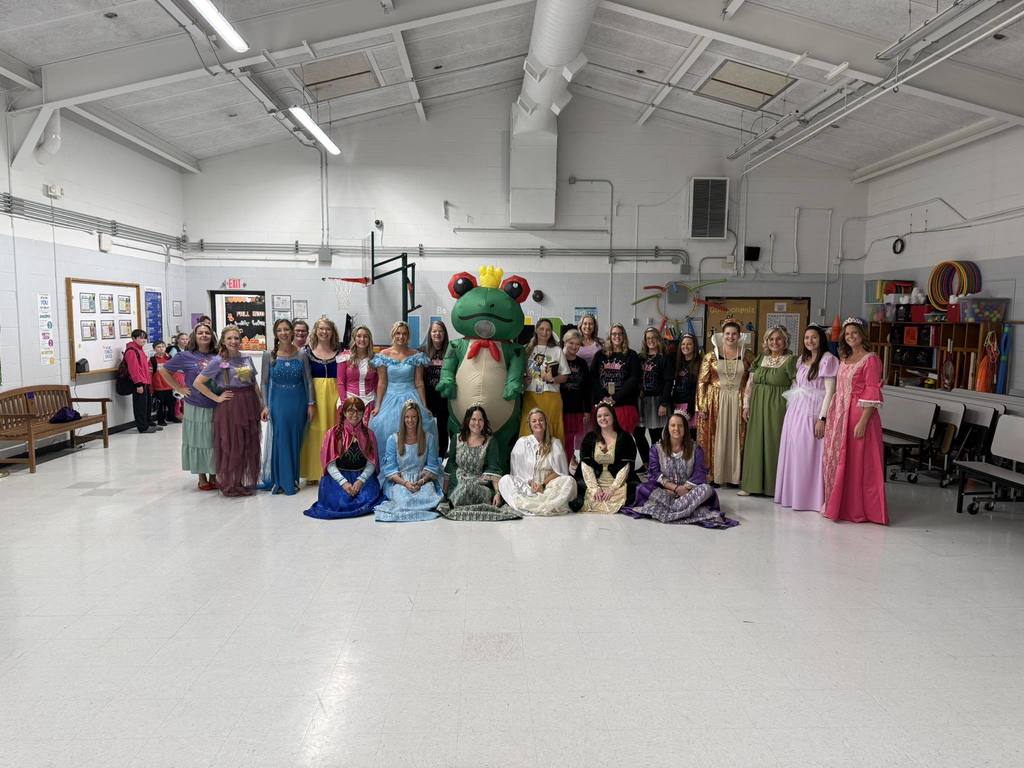The staff at Lakewood Elementary posing for a picture in their halloween costumes in the school cafeteria. 