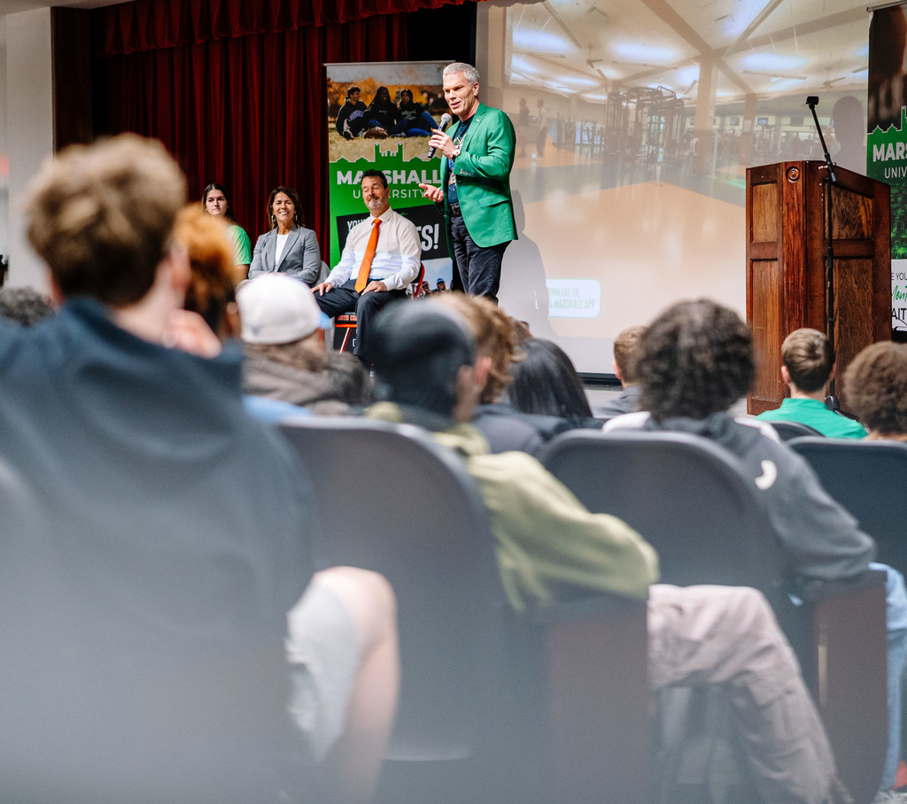 marshall university president, brad smith, on stage in the south charleston high school auditorium talking to students about what they can accomplish at marshall.