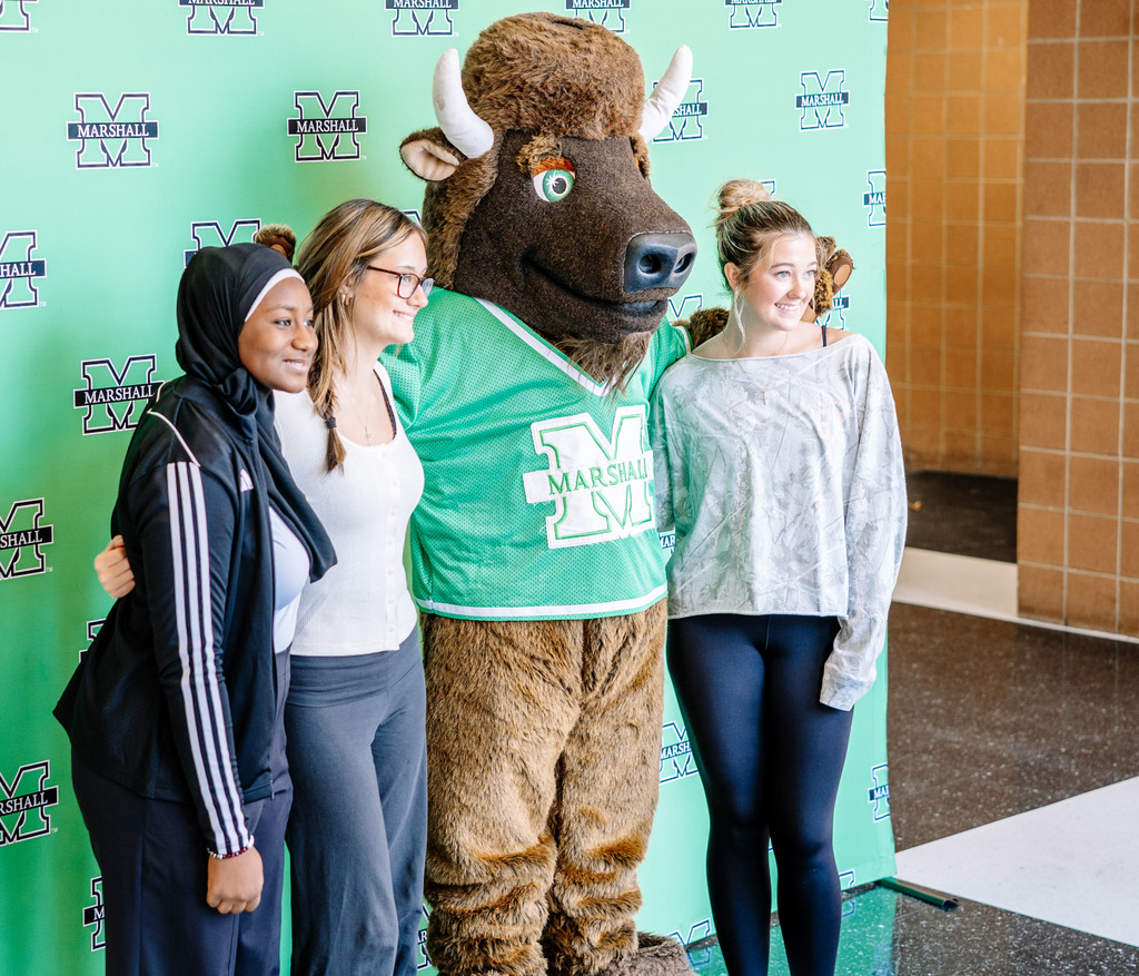 south charleston high school students posing for a picture with Marshall's mascot Marco.