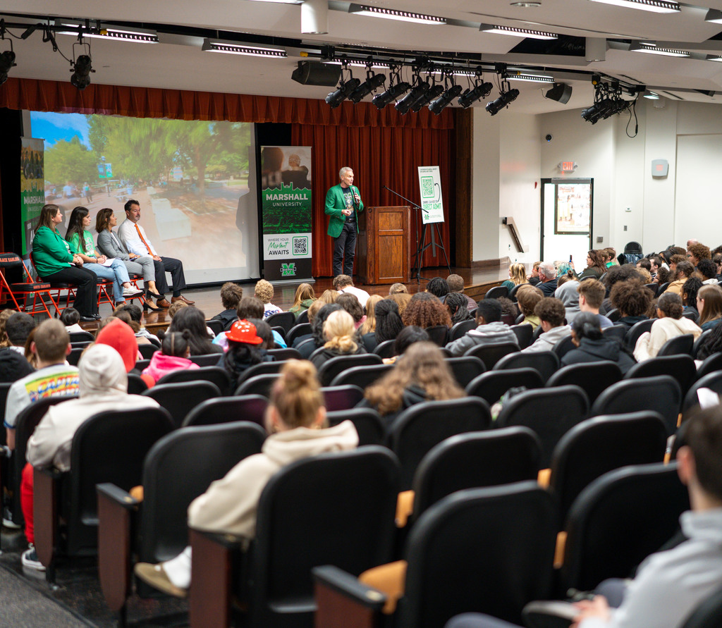 marshall university president, brad smith, on stage in the south charleston high school auditorium talking to students about what they can accomplish at marshall.