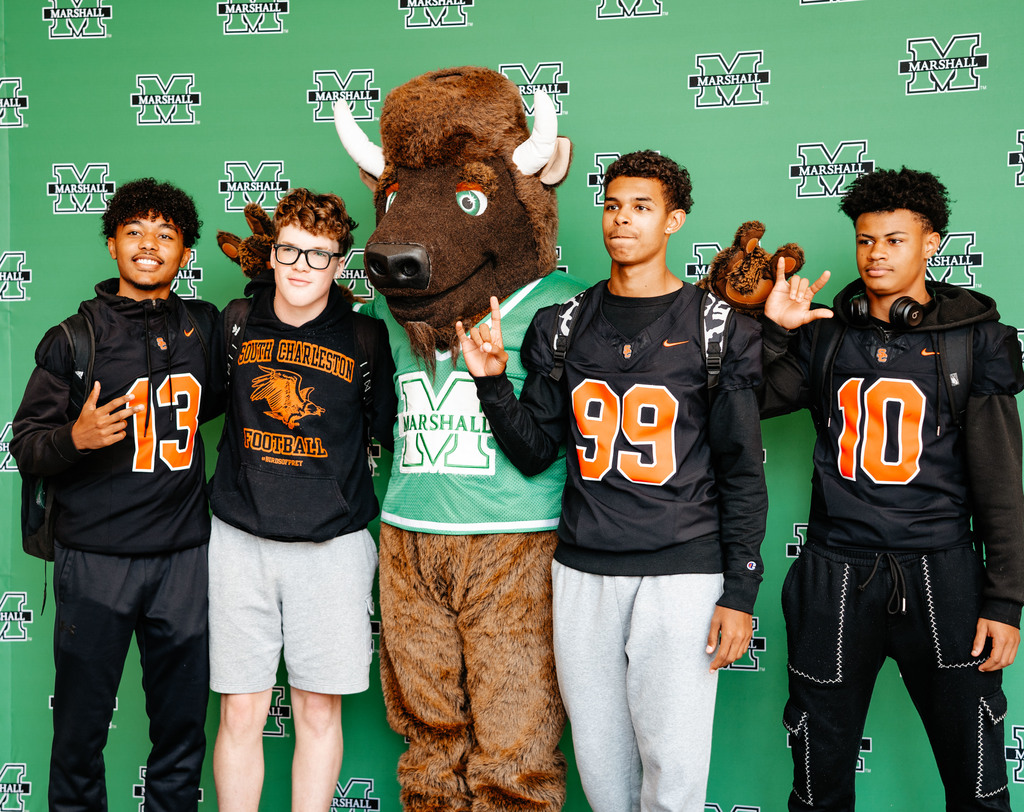 south charleston high school students posing for a picture with Marshall's mascot Marco.