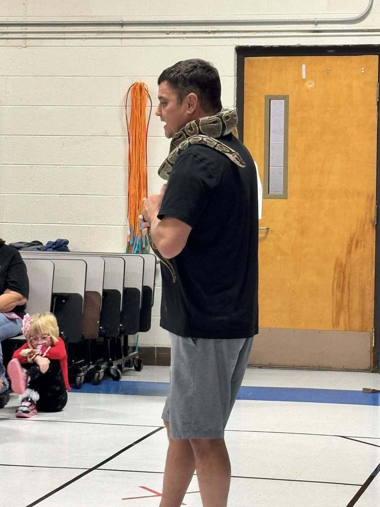 a member of the zoodles staff with a snake on his shoulders.