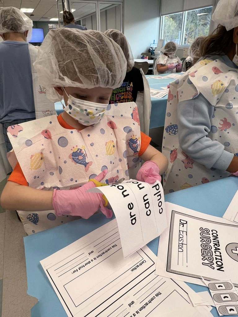 a student cutting out words during the contraction surgery lesson.
