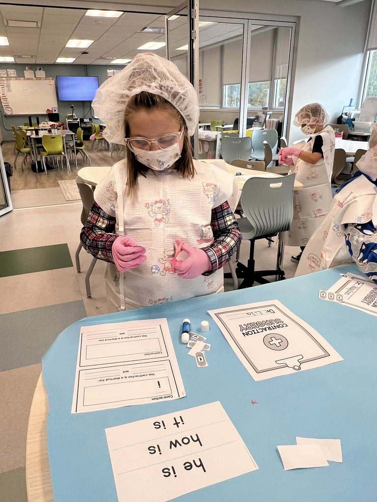 a student cutting a piece of paper during the lesson.