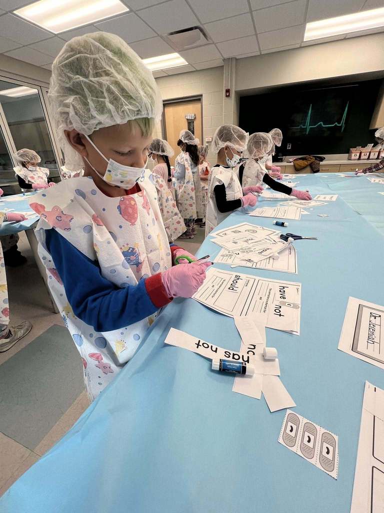 students cutting words out to make them into contractions.