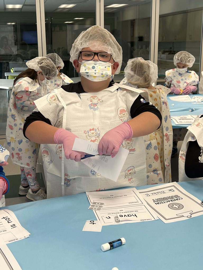 a student cutting words off of a piece of paper.