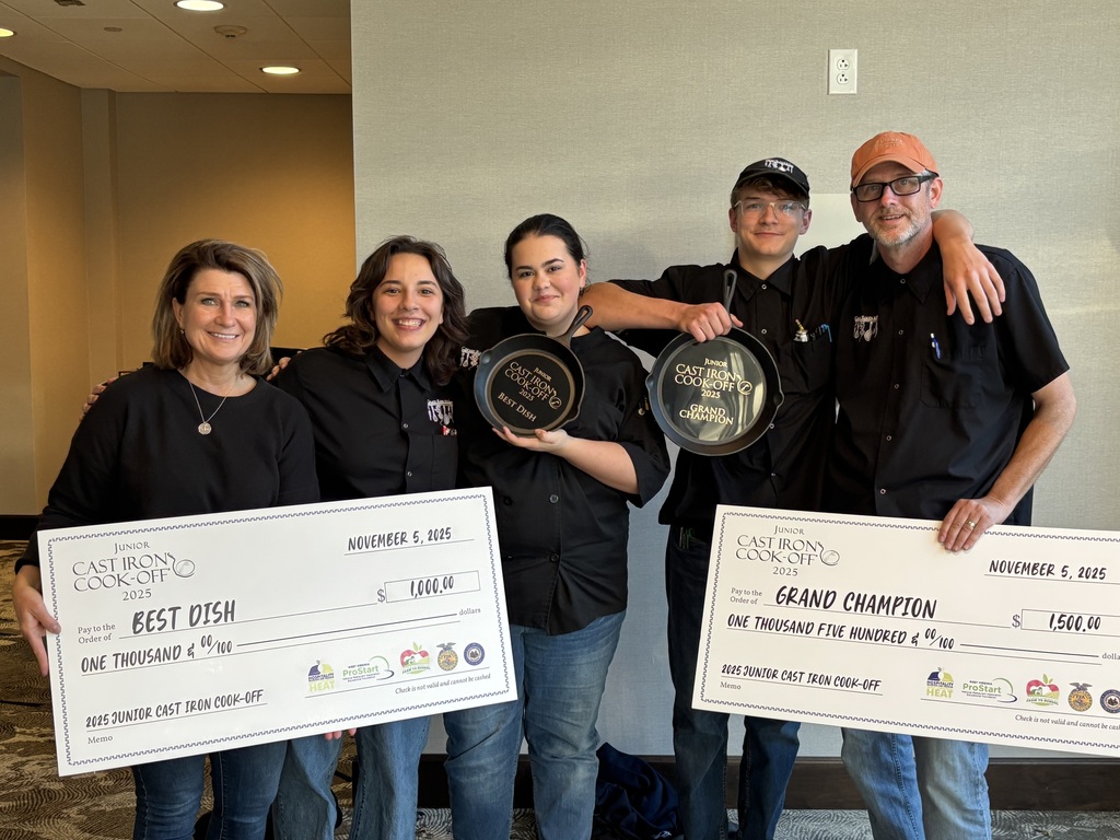 Carver Culinary students with their principal and instructor holding the prize checks for winning best dish and grand champion at the wv Jr. Cast Iron Cook-Off.