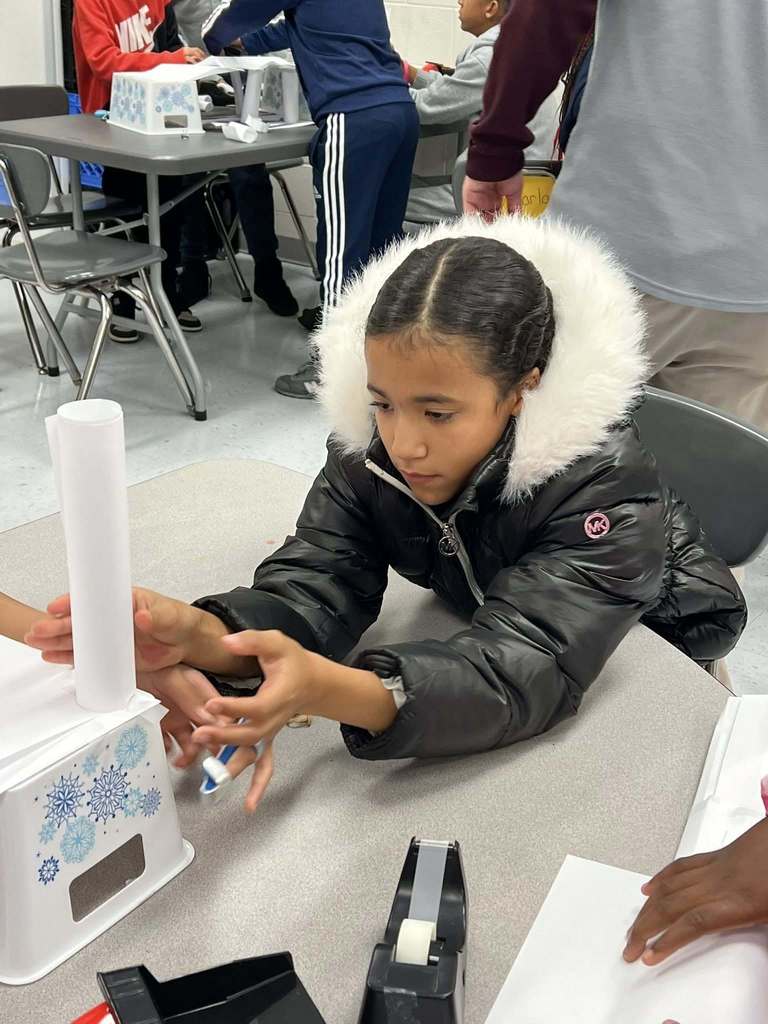 a student concentrating on a pillar for her bridge.