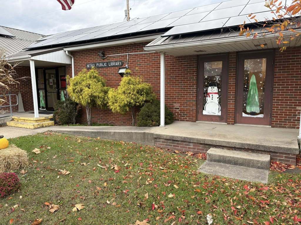the nitro public library with a snowman and christmas tree on the doors painted by art students at nitro high school.