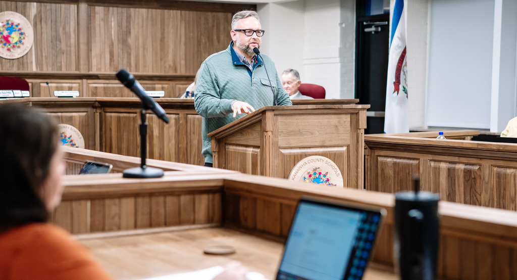 kcsboe president ric cavendar speaking at the podium in the kcs board room.