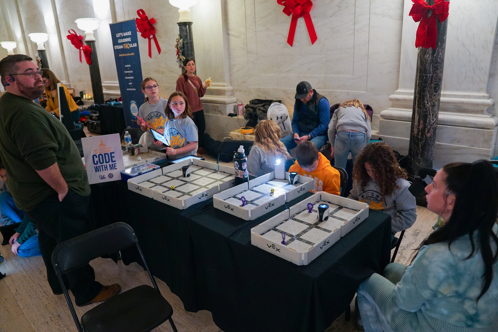 students at the capitol showing how their robots work.